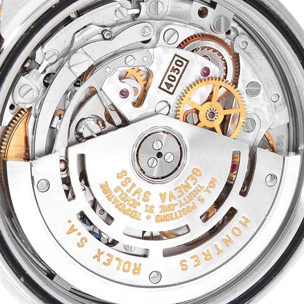 This image shows the internal parts and intricate mechanics of a Rolex Daytona 16523 Men's Steel and Gold (two tone) White Dial 16523 Men's Steel and Gold (two tone) White Dial watch, with gears and inscriptions visible.