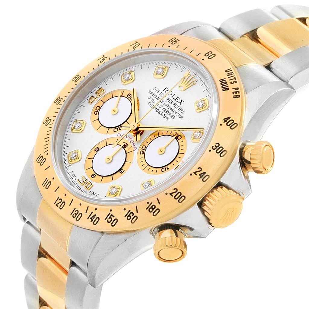 The image shows a close-up angle of the Rolex Daytona 16523 Men's Steel and Gold (two tone) White Dial 16523 Men's Steel and Gold (two tone) White Dial watch, featuring its dial, bezel, and side buttons.