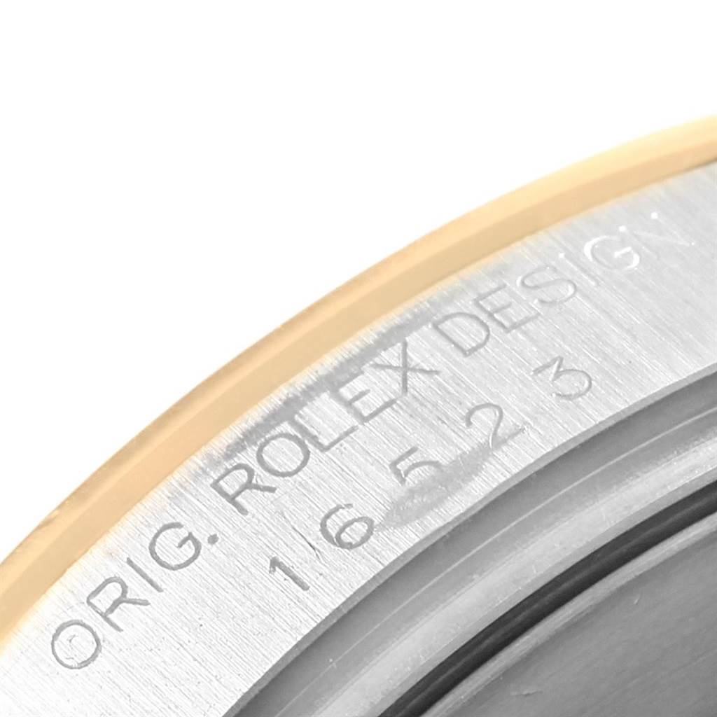 This image shows a close-up of the casing edge with engraved text referencing the Rolex Daytona 16523 Men's Steel and Gold (two tone) White Dial 16523 Men's Steel and Gold (two tone) White Dial model.