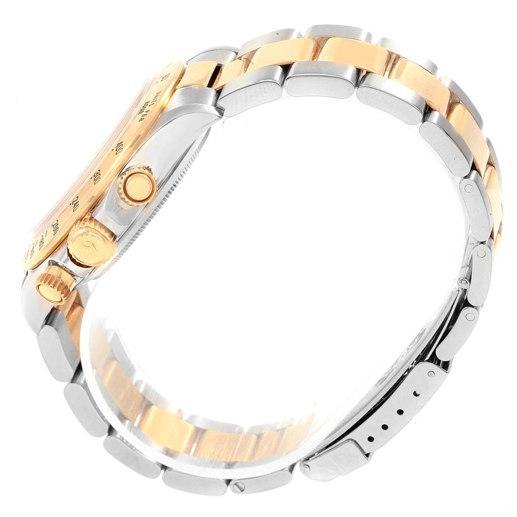 Side view of a Rolex Daytona 16523 Men's Steel and Gold (two tone) White Dial 16523 Men's Steel and Gold (two tone) White Dial watch, showcasing the gold and silver strap, crown, and pushers.