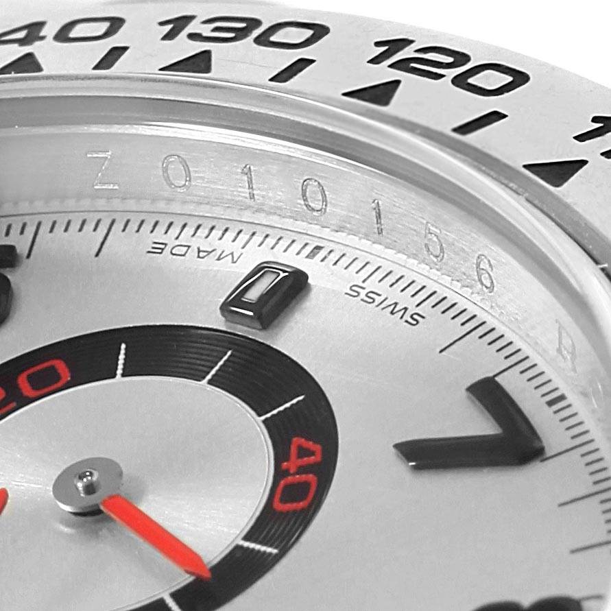 The image shows a close-up of the dial and bezel of a Rolex Daytona 116509 Men's White Gold Silver Dial 116509 Men's White Gold Silver Dial watch, displaying part of the tachymeter scale and hands.