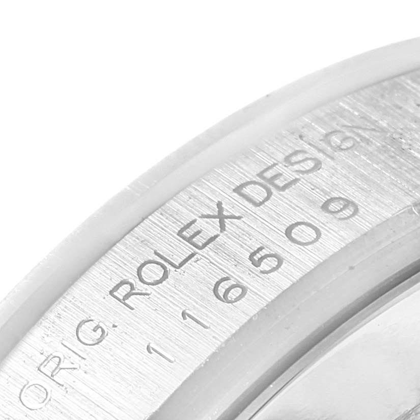 The image shows a close-up of the engraved inner bezel of a Rolex Daytona 116509 Men's White Gold Black Dial 116509 Men's White Gold Black Dial watch.