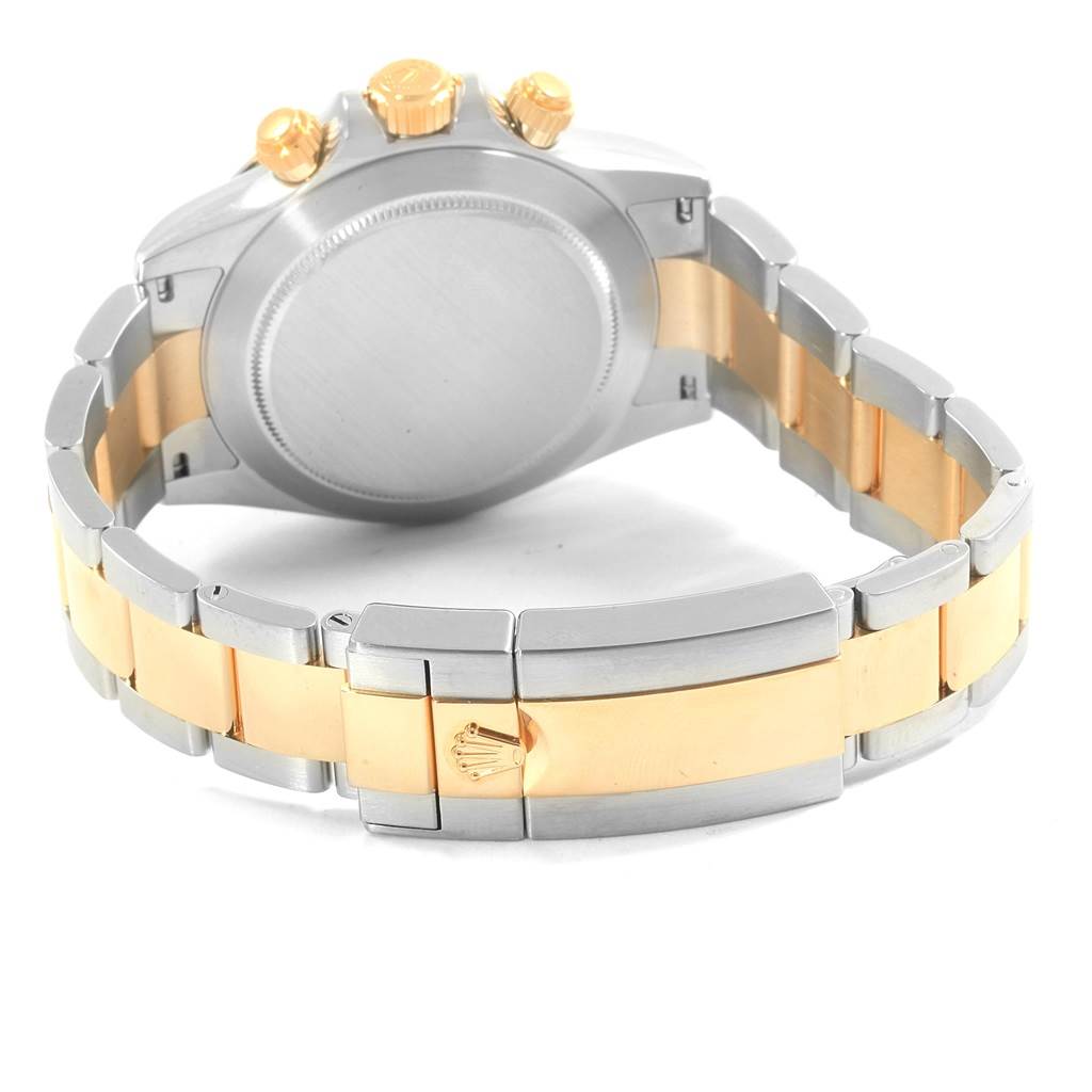 The image shows the back view of a Rolex Daytona 116523 Men's Steel and Gold (two tone) Grey Dial 116523 Men's Steel and Gold (two tone) Grey Dial watch, highlighting the metal bracelet and the clasp with the Rolex logo.