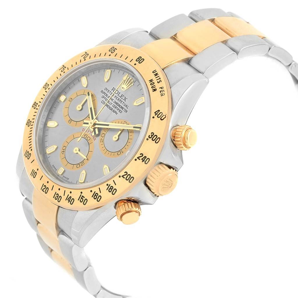 The image shows a Rolex Daytona 116523 Men's Steel and Gold (two tone) Grey Dial 116523 Men's Steel and Gold (two tone) Grey Dial watch from a front-left angle, highlighting the face, bezel, crown, pushers, and bracelet.