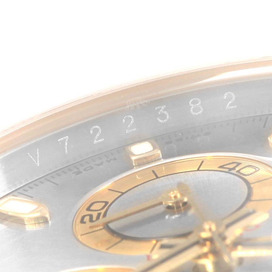 The image shows a close-up view of the dial and part of the bezel of the Rolex Daytona 116523 Men's Steel and Gold (two tone) Grey Dial 116523 Men's Steel and Gold (two tone) Grey Dial watch, highlighting the serial number.