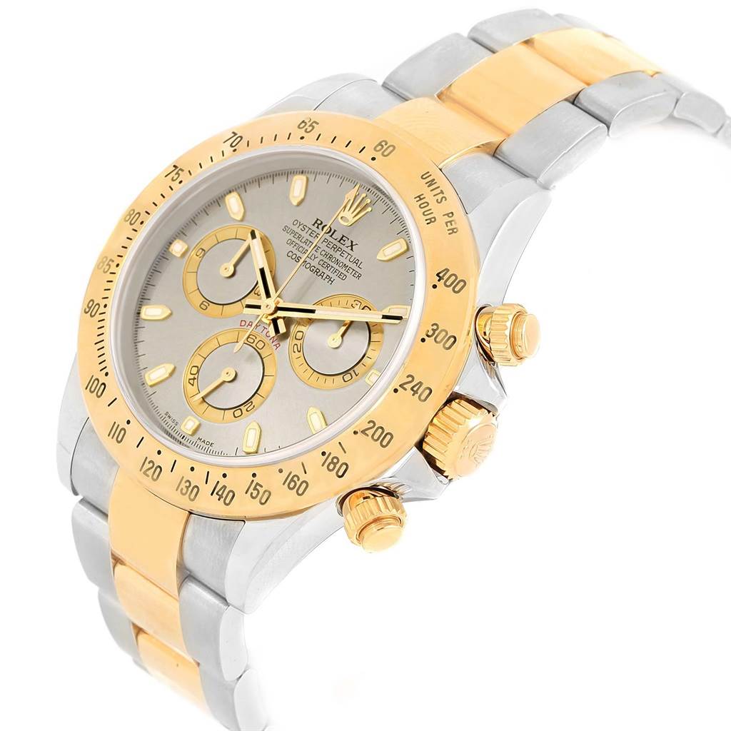 The image shows a Rolex Daytona 116523 Men's Steel and Gold (two tone) Grey Dial 116523 Men's Steel and Gold (two tone) Grey Dial watch, focused from an oblique angle, highlighting its gold bezel, crown, subdials, and two-tone bracelet.