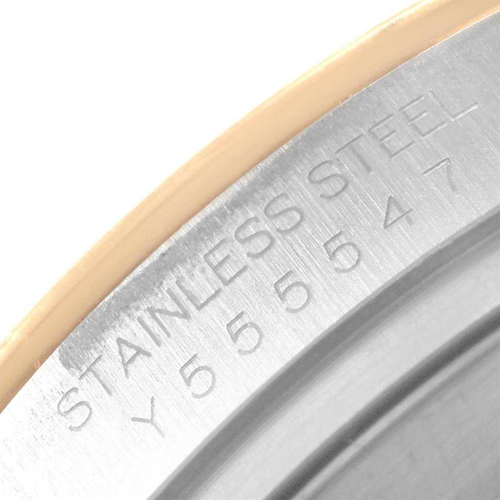 This close-up image shows the engraved stainless steel and serial number of the bezel for a Rolex Daytona 116523 Men's Steel and Gold (two tone) Grey Dial 116523 Men's Steel and Gold (two tone) Grey Dial watch.