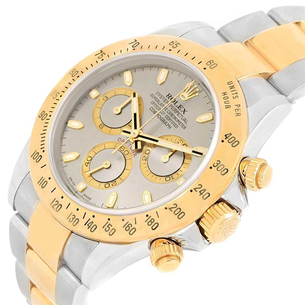 This image shows a close-up angle of the Rolex Daytona 116523 Men's Steel and Gold (two tone) Grey Dial 116523 Men's Steel and Gold (two tone) Grey Dial watch, highlighting its dial, bezel, and crown.