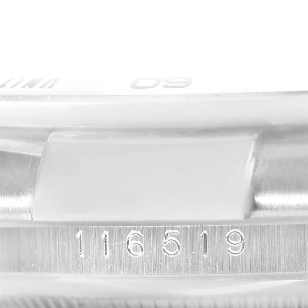 The image shows a close-up of a portion of a Rolex Daytona 116519 Men's White Gold White Dial 116519 Men's White Gold White Dial watch, focusing on the engraved model number 116519 on the case.