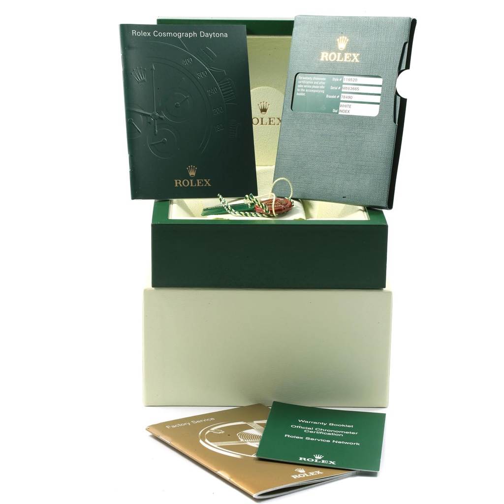 The image shows Rolex Daytona 116520 Men's Stainless Steel White Dial 116520 Men's Stainless Steel White Dial model watch accessories, including manuals, a warranty card, tags, and the original packaging box.
