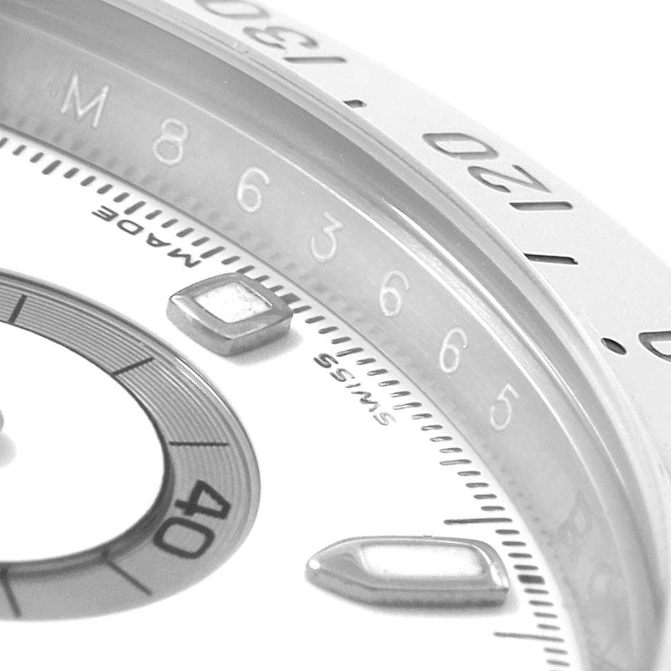 The image shows a close-up of the bezel and dial of a Rolex Daytona 116520 Men's Stainless Steel White Dial 116520 Men's Stainless Steel White Dial watch, highlighting the minute markers and part of a subdial.