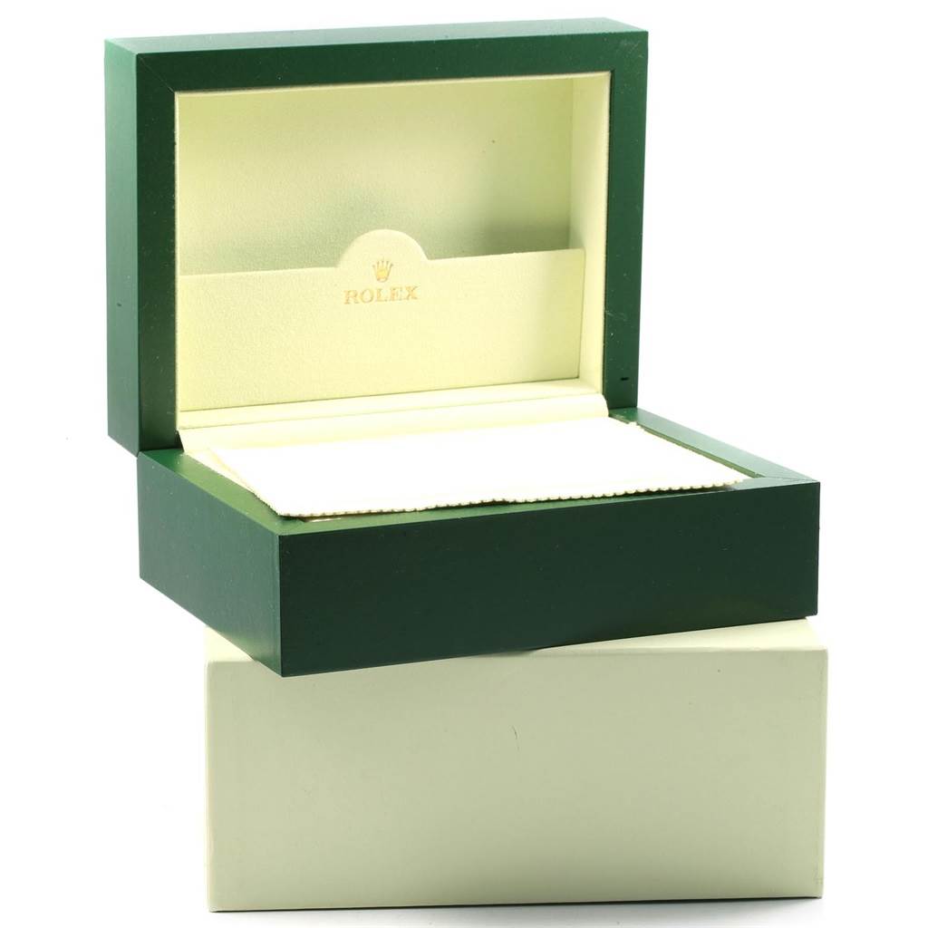 The image shows an open green and beige Rolex watch box, likely for a Daytona model, viewed from the front.