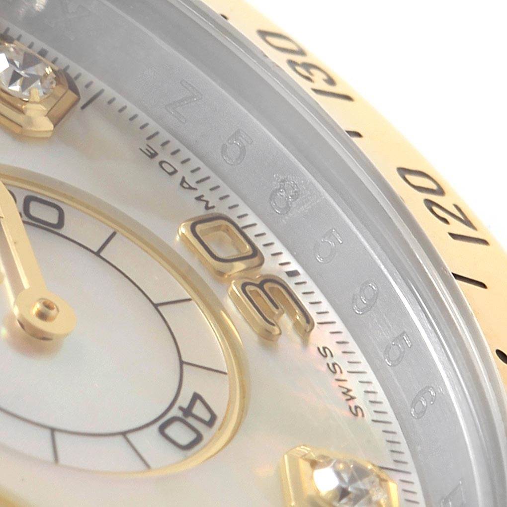 The image shows a close-up of the dial and bezel of a Rolex Daytona 116523 Men
s Steel and Gold (two tone) Mother of Pearl Dial 116523 Men
s Steel and Gold (two tone) Mother of Pearl Dial watch, highlighting gold markers and crystal detailing.