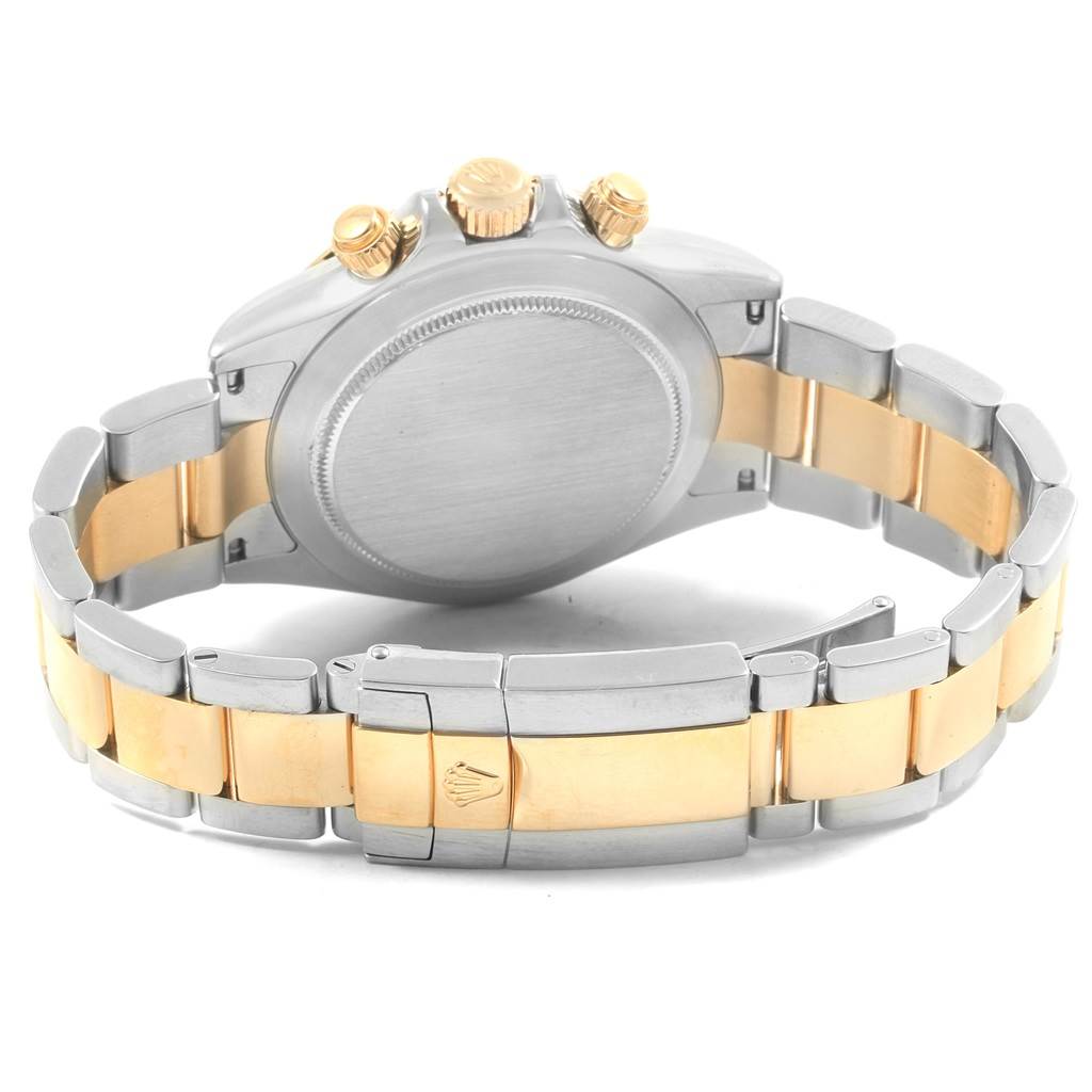 This image shows the back case, crown, and bracelet of a Rolex Daytona 116523 Men's Steel and Gold (two tone) White Dial 116523 Men's Steel and Gold (two tone) White Dial watch.