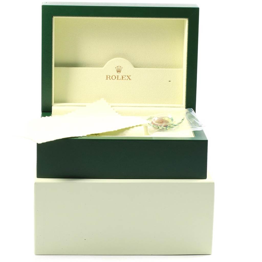 This image shows an open Rolex Daytona 116523 Men's Steel and Gold (two tone) White Dial 116523 Men's Steel and Gold (two tone) White Dial watch box, displaying its interior and a cleaning cloth.