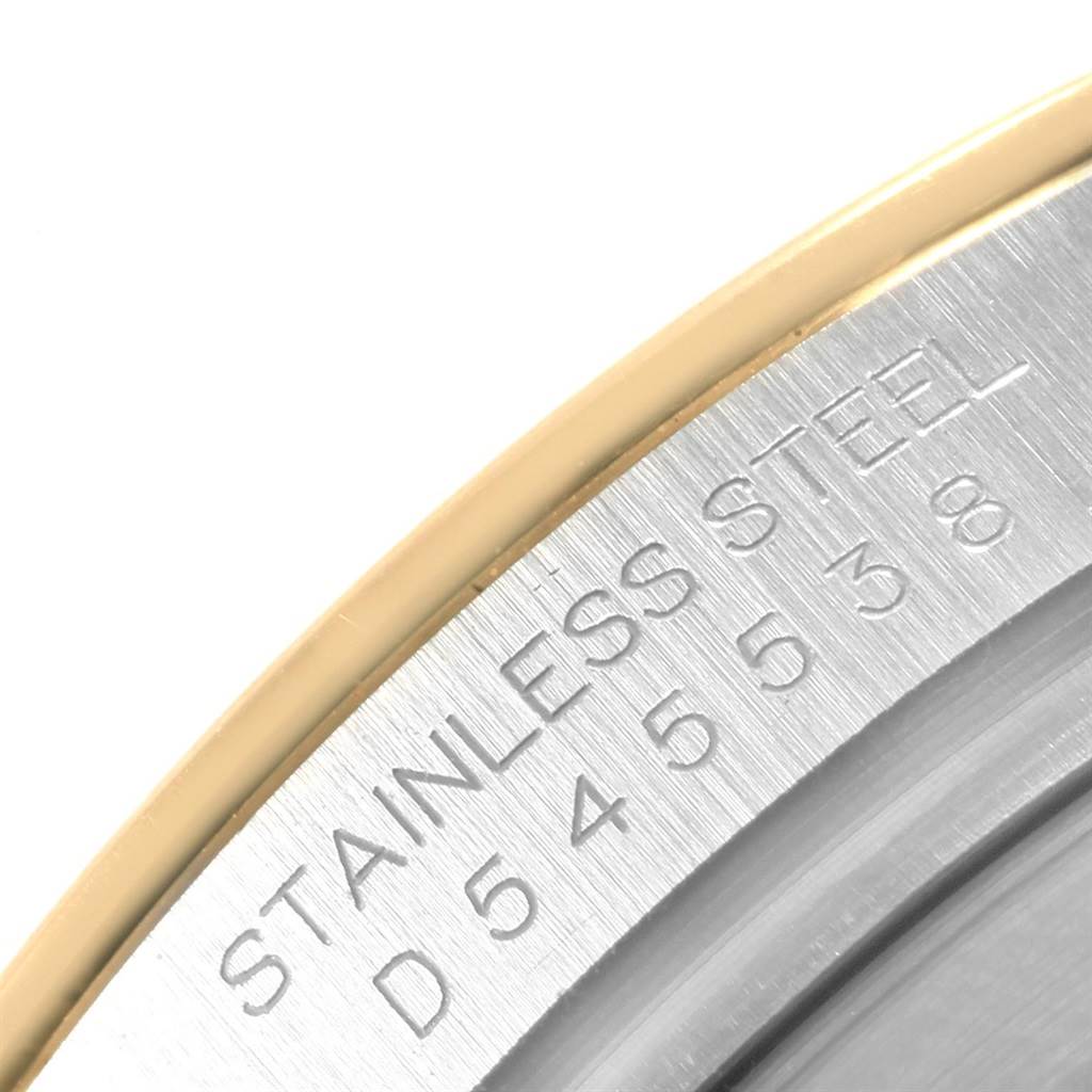 The image shows a close-up of the engraved text on the stainless steel bezel of a Rolex Daytona 116523 Men's Steel and Gold (two tone) Grey Dial 116523 Men's Steel and Gold (two tone) Grey Dial watch.
