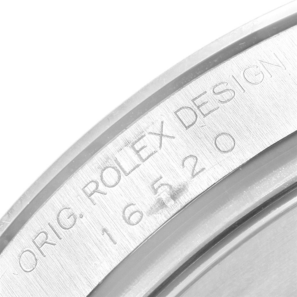 This image shows a close-up of the engraved casing side of the Rolex Daytona 16520 Men's Stainless Steel White Dial 16520 Men's Stainless Steel White Dial watch.