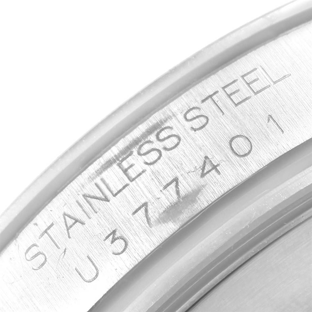 This image shows a close-up of the caseback of a Rolex Daytona 16520 Men's Stainless Steel White Dial 16520 Men's Stainless Steel White Dial watch, highlighting its serial number and "Stainless Steel" inscription.