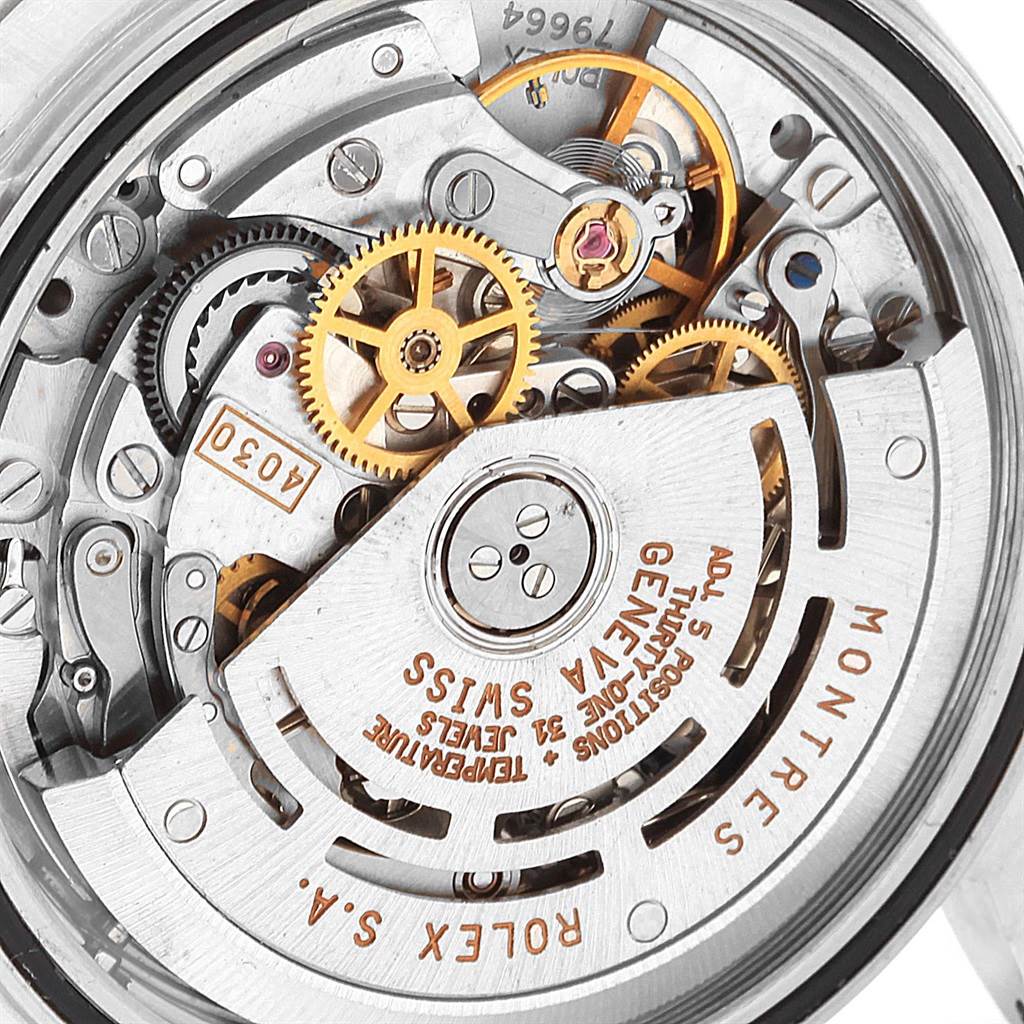 This is a close-up of the movement mechanism of a Rolex Daytona 16520 Men's Stainless Steel Black Dial 16520 Men's Stainless Steel Black Dial watch, showcasing gears, jewels, and the rotor.