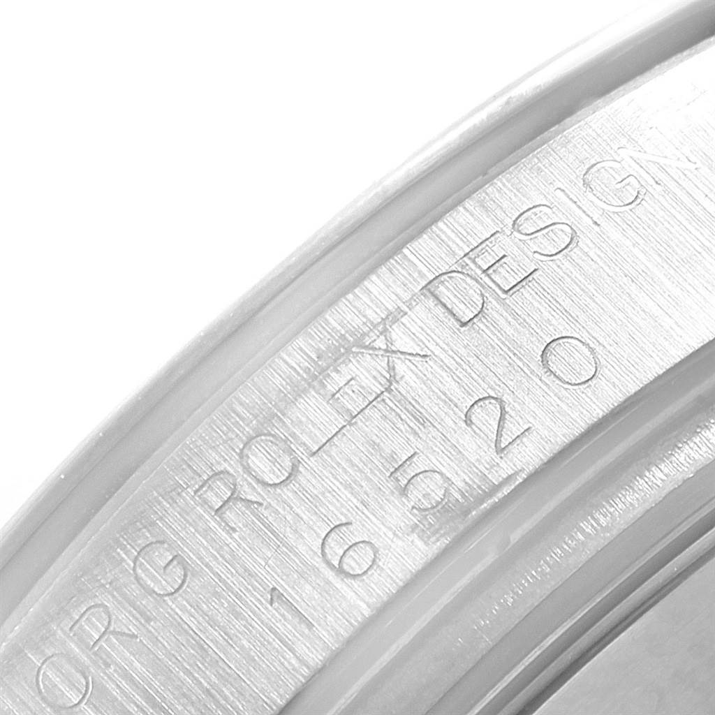 The image shows a close-up of the engraved serial number on the inner bezel of a Rolex Daytona 16520 Men's Stainless Steel Black Dial 16520 Men's Stainless Steel Black Dial watch.