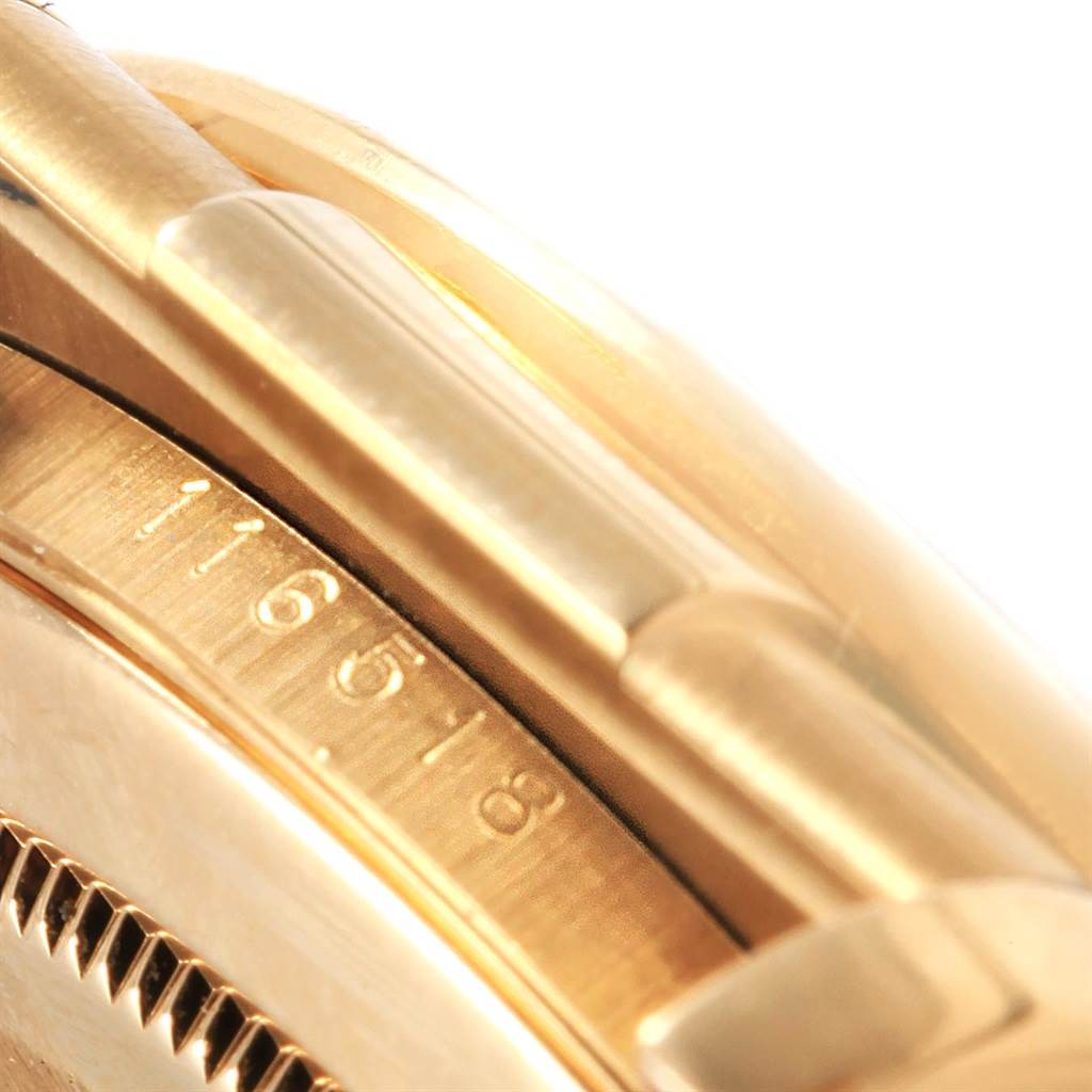 This close-up image of a Rolex Daytona 116518 Men's Yellow Gold Blue Dial 116518 Men's Yellow Gold Blue Dial watch shows part of the bracelet and the side of the watch case, displaying the model number.