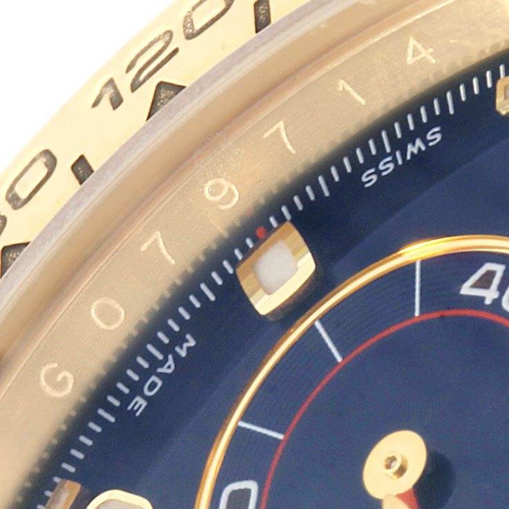 The close-up image shows a portion of the dial and bezel of a Rolex Daytona 116518 Men's Yellow Gold Blue Dial 116518 Men's Yellow Gold Blue Dial watch, highlighting the chronograph sub-dial and numeric markings.