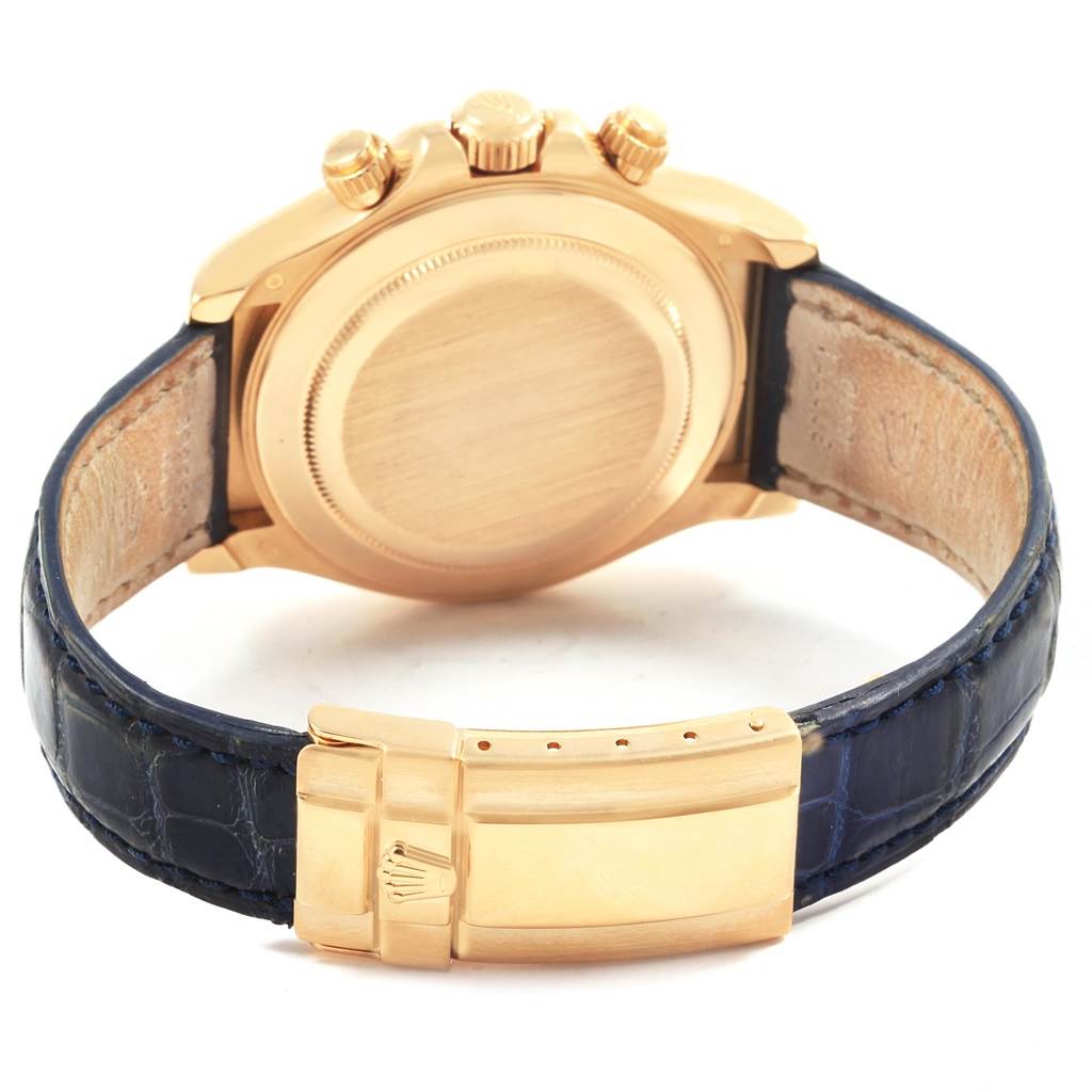 This image shows the back and clasp of a Rolex Daytona 116518 Men's Yellow Gold Blue Dial 116518 Men's Yellow Gold Blue Dial watch, featuring a gold case and a blue leather strap.