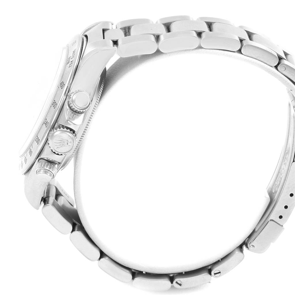 The image shows a side profile of a Rolex Daytona 16520 Men's Stainless Steel White Dial 16520 Men's Stainless Steel White Dial watch, highlighting its crown, pushers, and part of the bracelet.