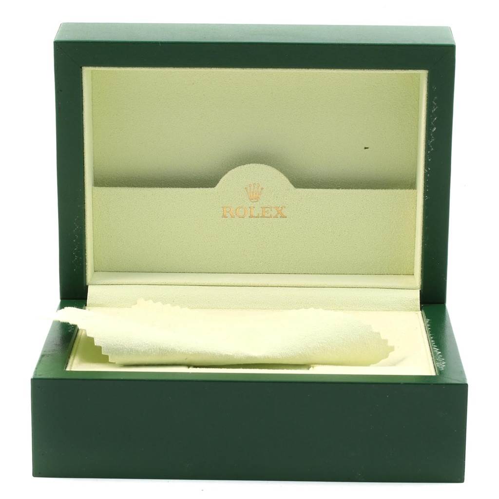 The image shows an open green and beige Rolex box for the Daytona model watch, with the Rolex logo inside.