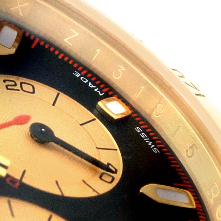 This close-up shot of the Rolex Daytona 116528 Men's Yellow Gold Black Dial 116528 Men's Yellow Gold Black Dial watch showcases part of the dial, markers, and hands with the "Swiss Made" text visible.