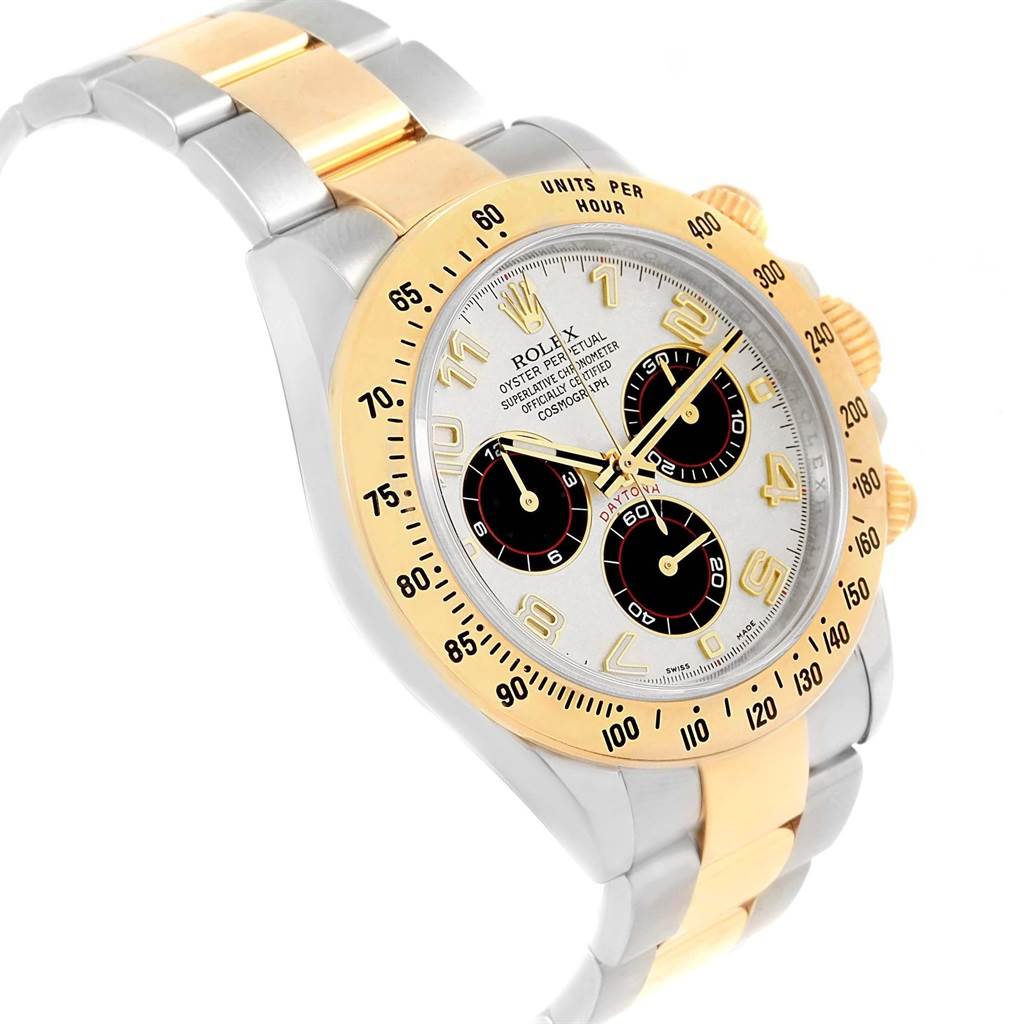 The image shows a Rolex Daytona 116523 Men's Steel and Gold (two tone) White Dial 116523 Men's Steel and Gold (two tone) White Dial watch at an angled view, highlighting its bezel, dial, and two-tone bracelet.