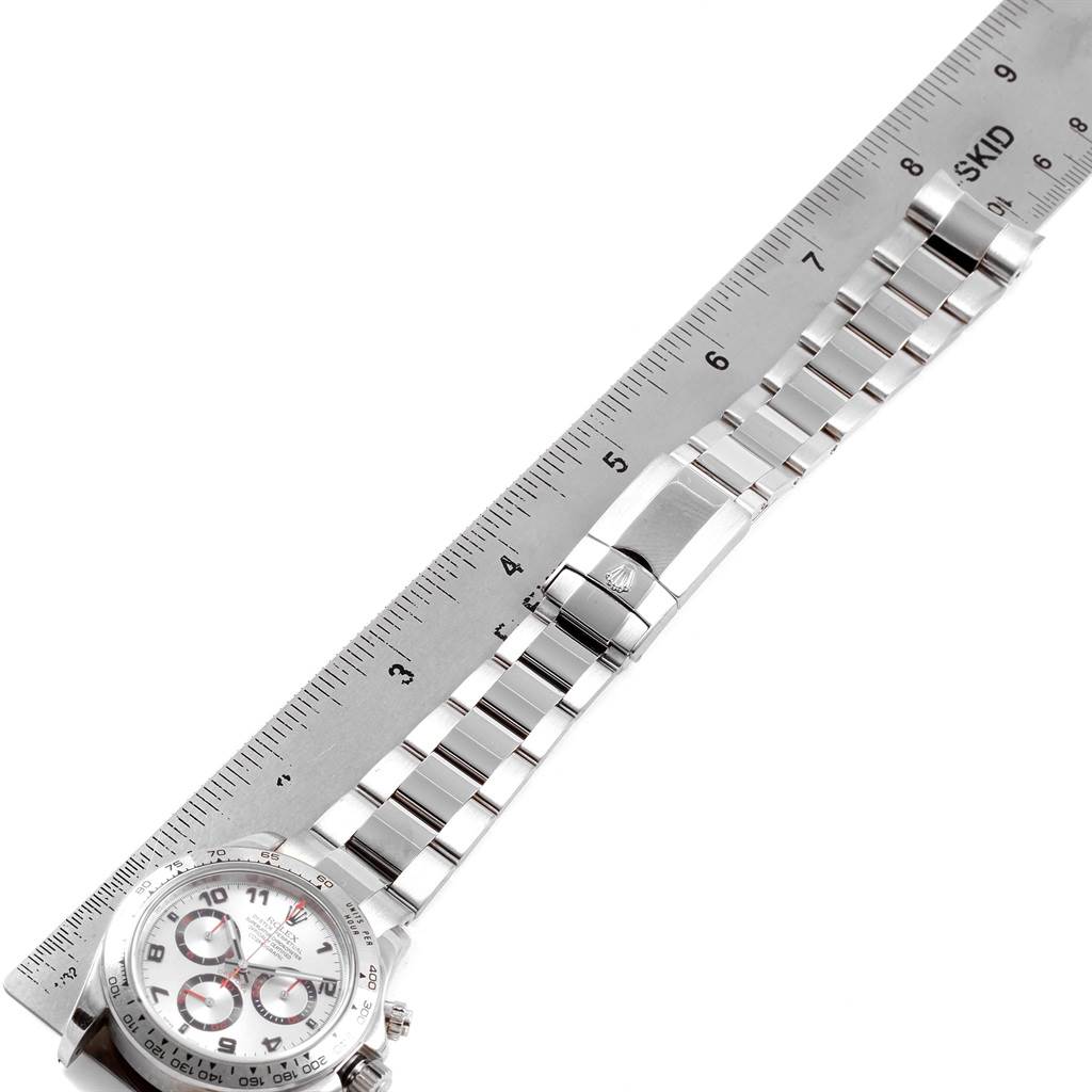 The image shows the Rolex Daytona 116509 Men's White Gold Silver Dial 116509 Men's White Gold Silver Dial watch laid next to a ruler, highlighting its dial, bracelet, and clasp.