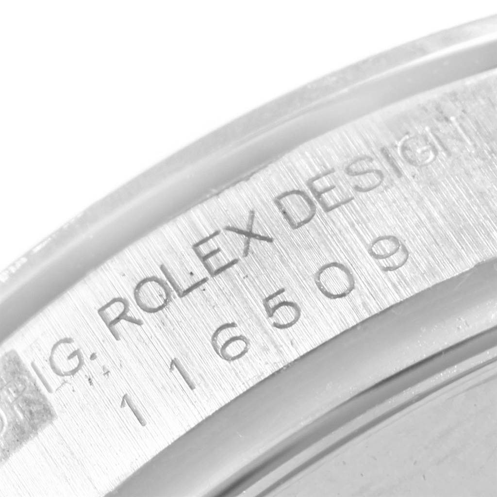 The image shows a close-up of the case edge of the Rolex Daytona 116509 Men's White Gold Silver Dial 116509 Men's White Gold Silver Dial, featuring the model number and "Rolex Design" engraving.