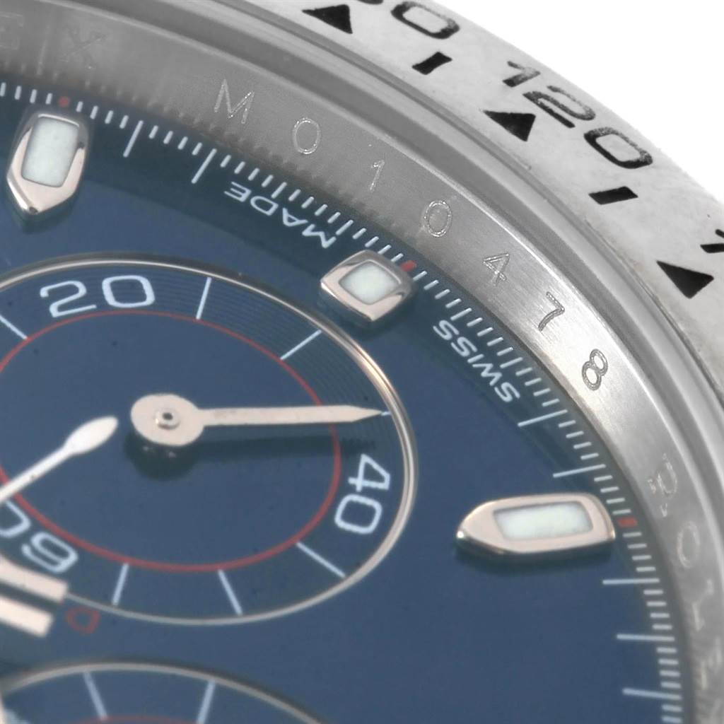 The image shows a close-up of a Rolex Daytona 116509 Men's White Gold Blue Dial 116509 Men's White Gold Blue Dial watch, focusing on its dial, subdials, and part of the bezel from an angled perspective.
