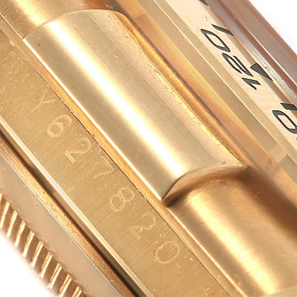 The close-up image shows the side engraving and part of the bezel of a Rolex Daytona 116518 Men's Yellow Gold Mother of Pearl Dial 116518 Men's Yellow Gold Mother of Pearl Dial watch.