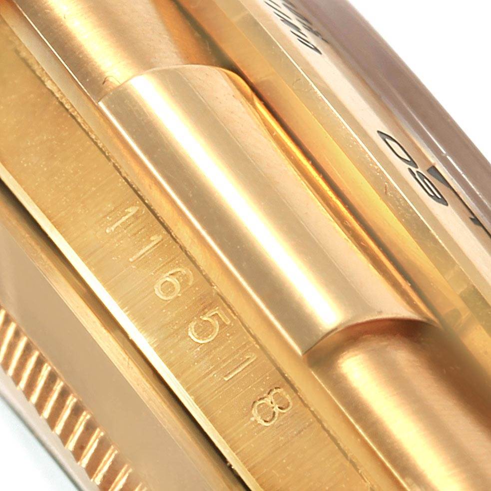 This close-up image shows the side profile of the Rolex Daytona 116518 Men's Yellow Gold Mother of Pearl Dial 116518 Men's Yellow Gold Mother of Pearl Dial watch, highlighting part of the case and the model number engraved.