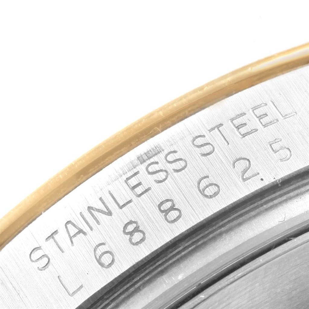 This image shows a close-up view of the stainless steel casing and engraved details of a Rolex Daytona 16523 Men's Steel and Gold (two tone) Black Dial 16523 Men's Steel and Gold (two tone) Black Dial watch.