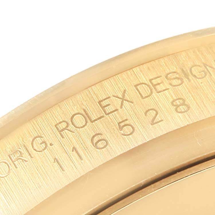 This close-up angle shows the engraved text on the side of a Rolex Daytona 116528 Men's Yellow Gold Champagne Dial 116528 Men's Yellow Gold Champagne Dial watch case.
