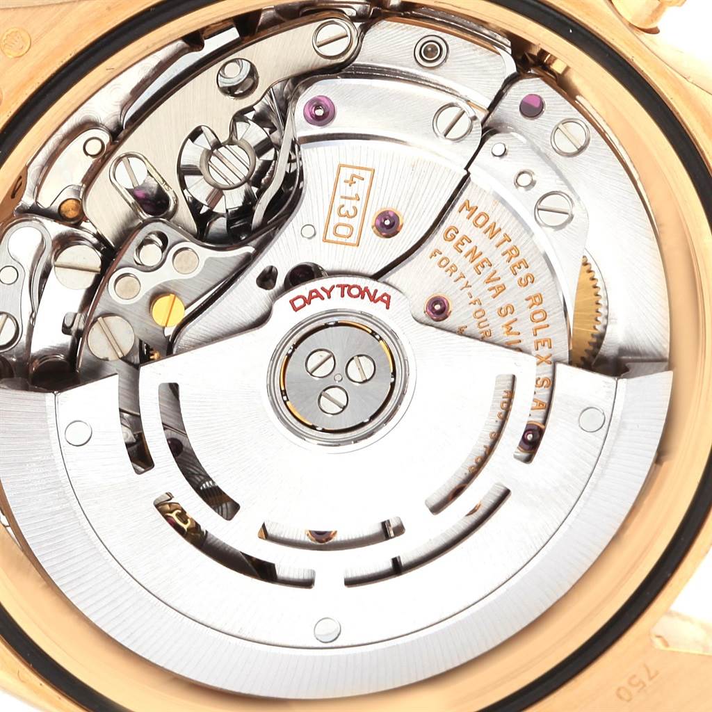 The image shows a close-up of the movement and intricate internal mechanisms of a Rolex Daytona 116528 Men's Yellow Gold Champagne Dial 116528 Men's Yellow Gold Champagne Dial watch.