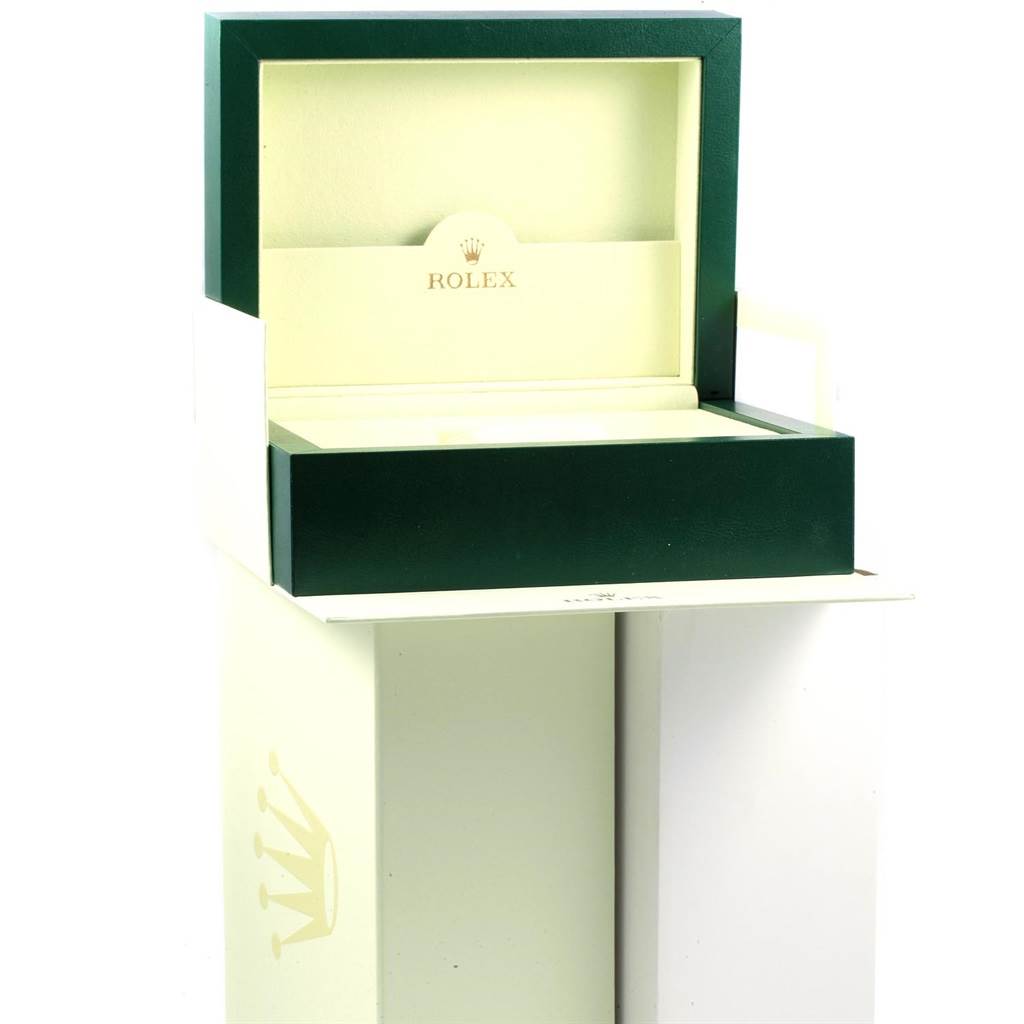 The image shows an open Rolex Daytona 116528 Men's Yellow Gold Champagne Dial 116528 Men's Yellow Gold Champagne Dial watch box, revealing its interior cushion and distinct green and cream color scheme.