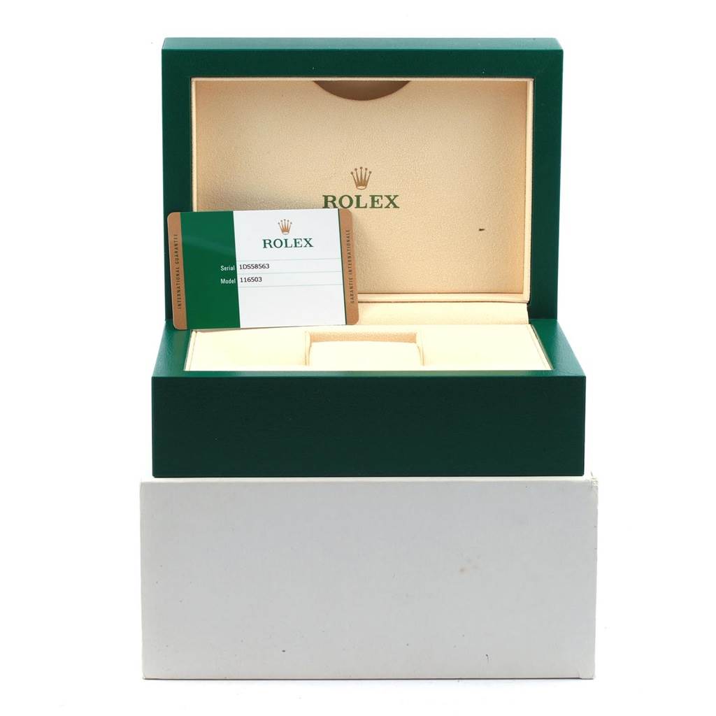This image shows an open green Rolex box for the Daytona model, accompanied by a warranty card on the inside.