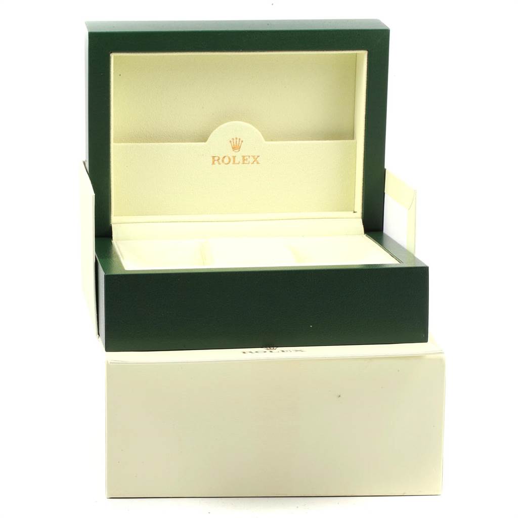 The image shows an open green and cream-colored Rolex box for a Daytona model.