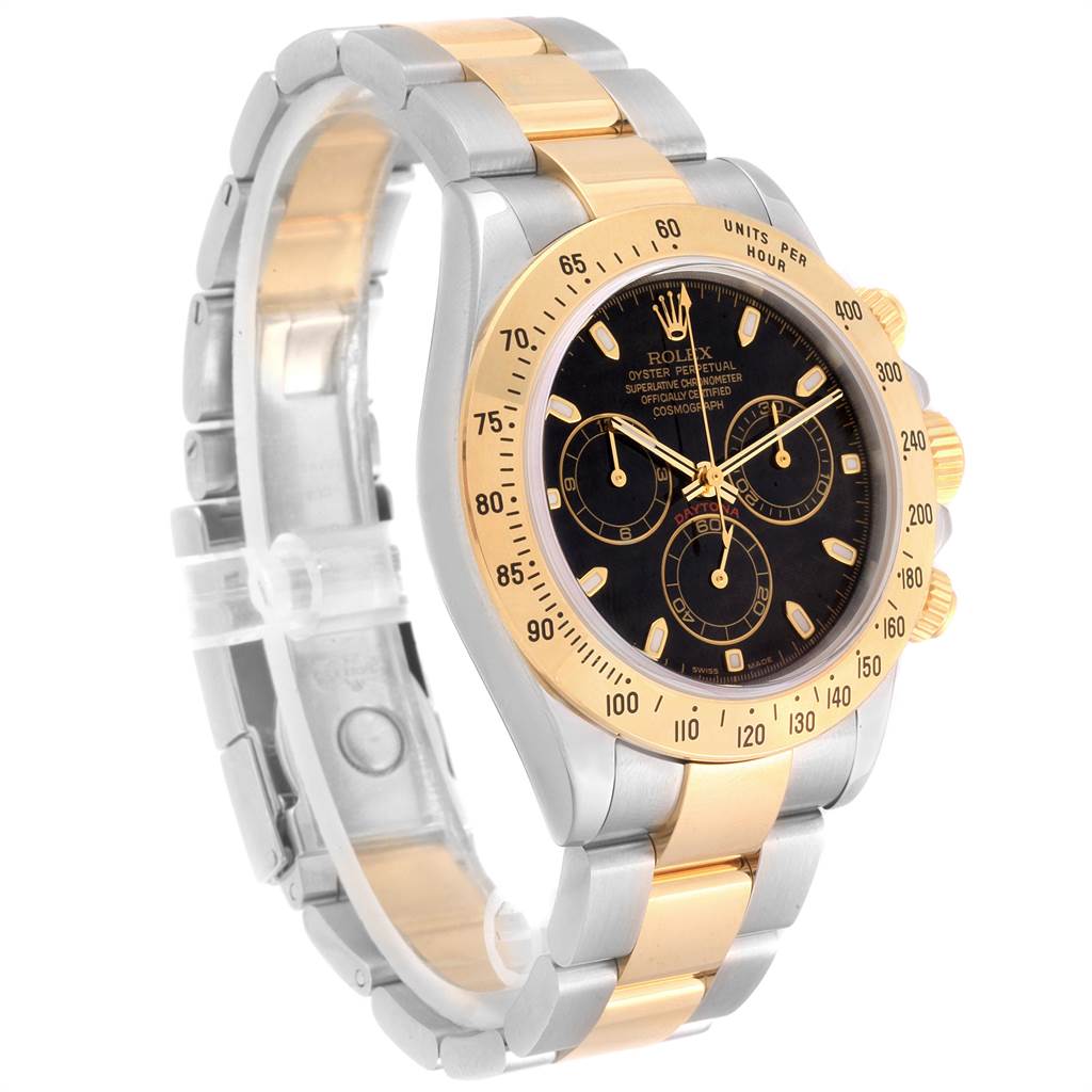 The image shows a Rolex Daytona 116523 Men's Steel and Gold (two tone) Black Dial 116523 Men's Steel and Gold (two tone) Black Dial watch at a three-quarter angle, featuring a black dial, gold bezel, and a two-tone bracelet.