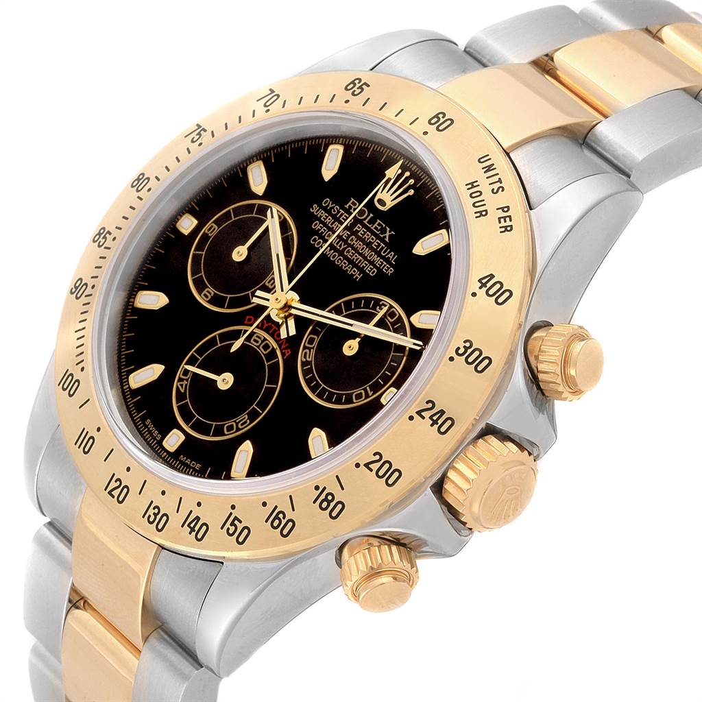 This Rolex Daytona 116523 Men's Steel and Gold (two tone) Black Dial 116523 Men's Steel and Gold (two tone) Black Dial model is shown from a three-quarter angle, highlighting its gold bezel, black dial, and two-tone bracelet.