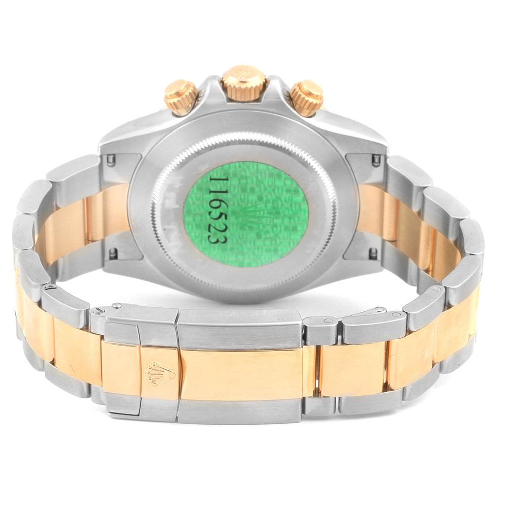 The image shows the back view of a Rolex Daytona 116523 Men's Steel and Gold (two tone) Black Dial 116523 Men's Steel and Gold (two tone) Black Dial watch, highlighting its clasp, caseback, and bracelet.