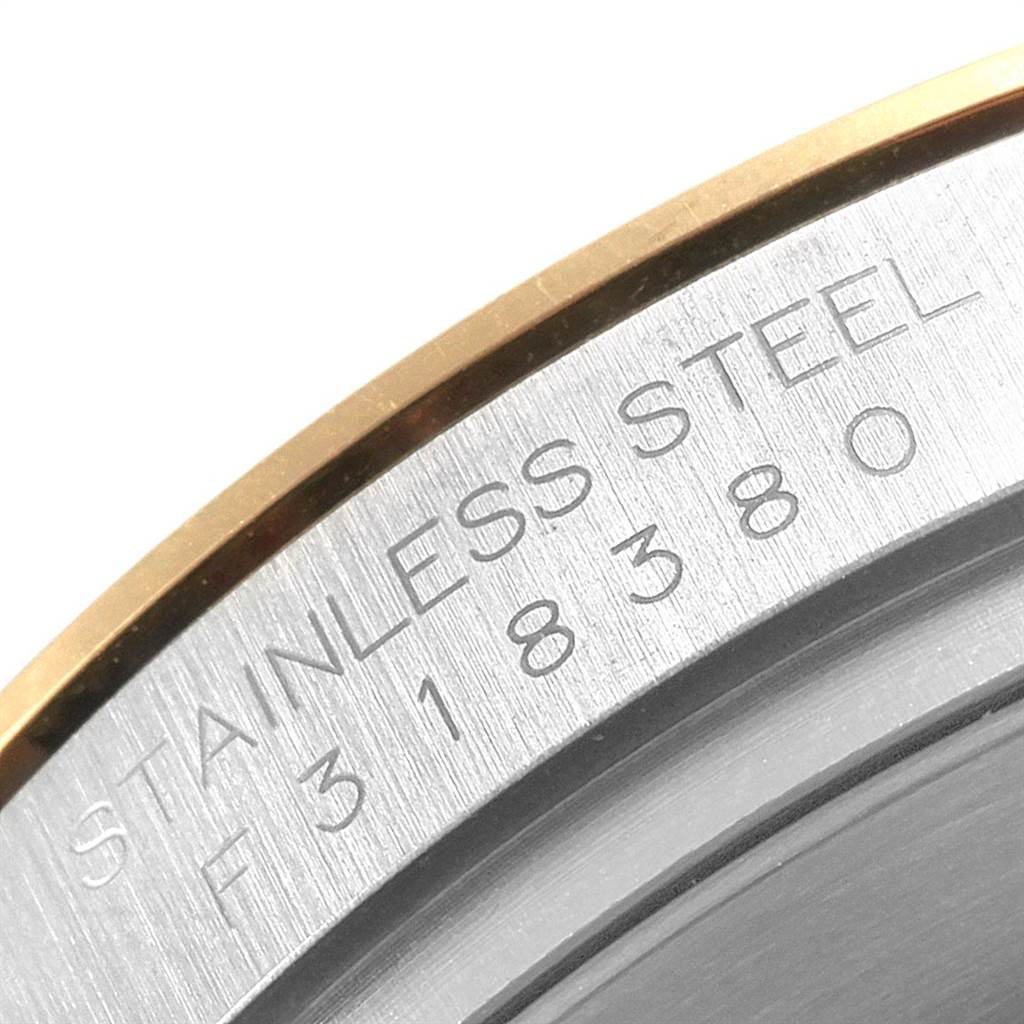 This image shows a close-up of the stainless steel case back on a Rolex Daytona 116523 Men's Steel and Gold (two tone) Black Dial 116523 Men's Steel and Gold (two tone) Black Dial watch, highlighting the engraved text.