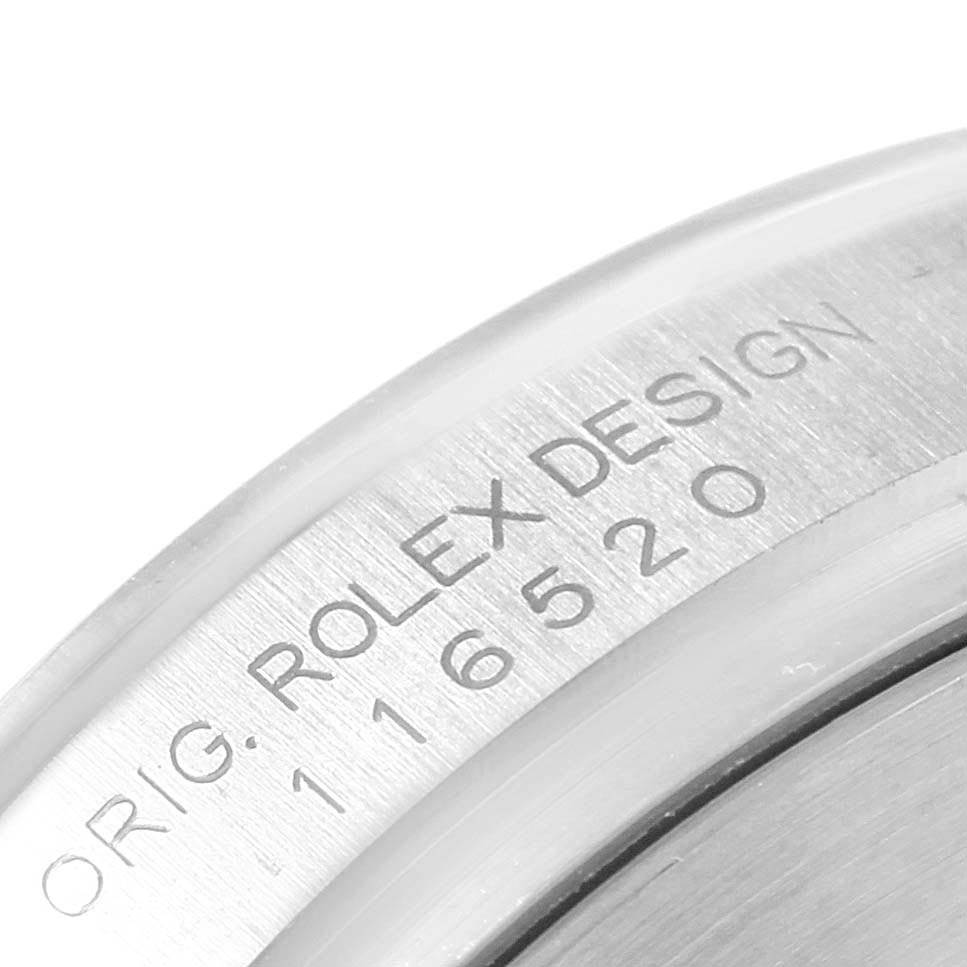 The image shows a close-up of the engraving on the side of the case of a Rolex Daytona 116520 Men's Stainless Steel Black Dial 116520 Men's Stainless Steel Black Dial watch.