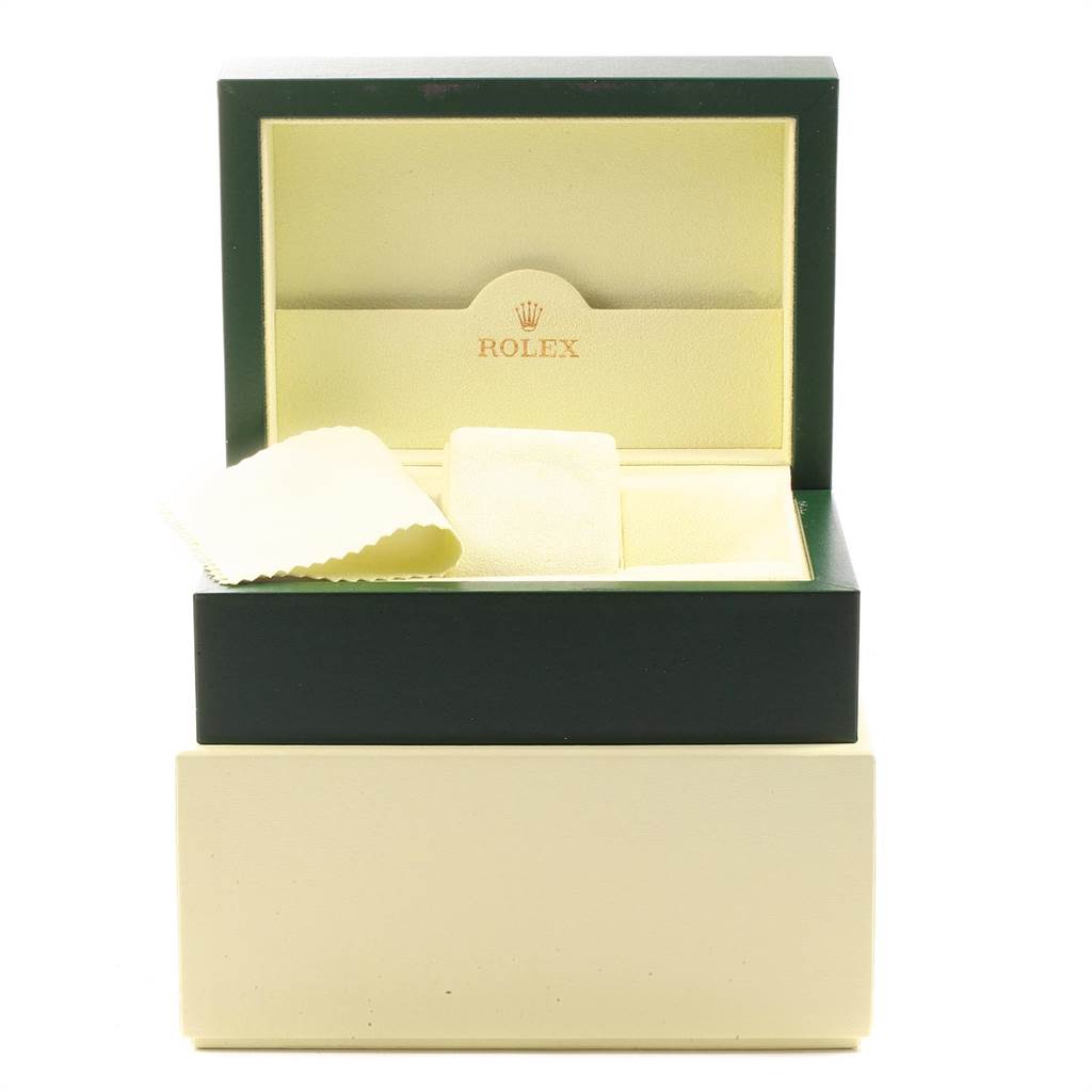 The image shows an open Rolex Daytona 116520 Men
s Stainless Steel Black Dial 116520 Men
s Stainless Steel Black Dial watch box with a cushion and a cleaning cloth.