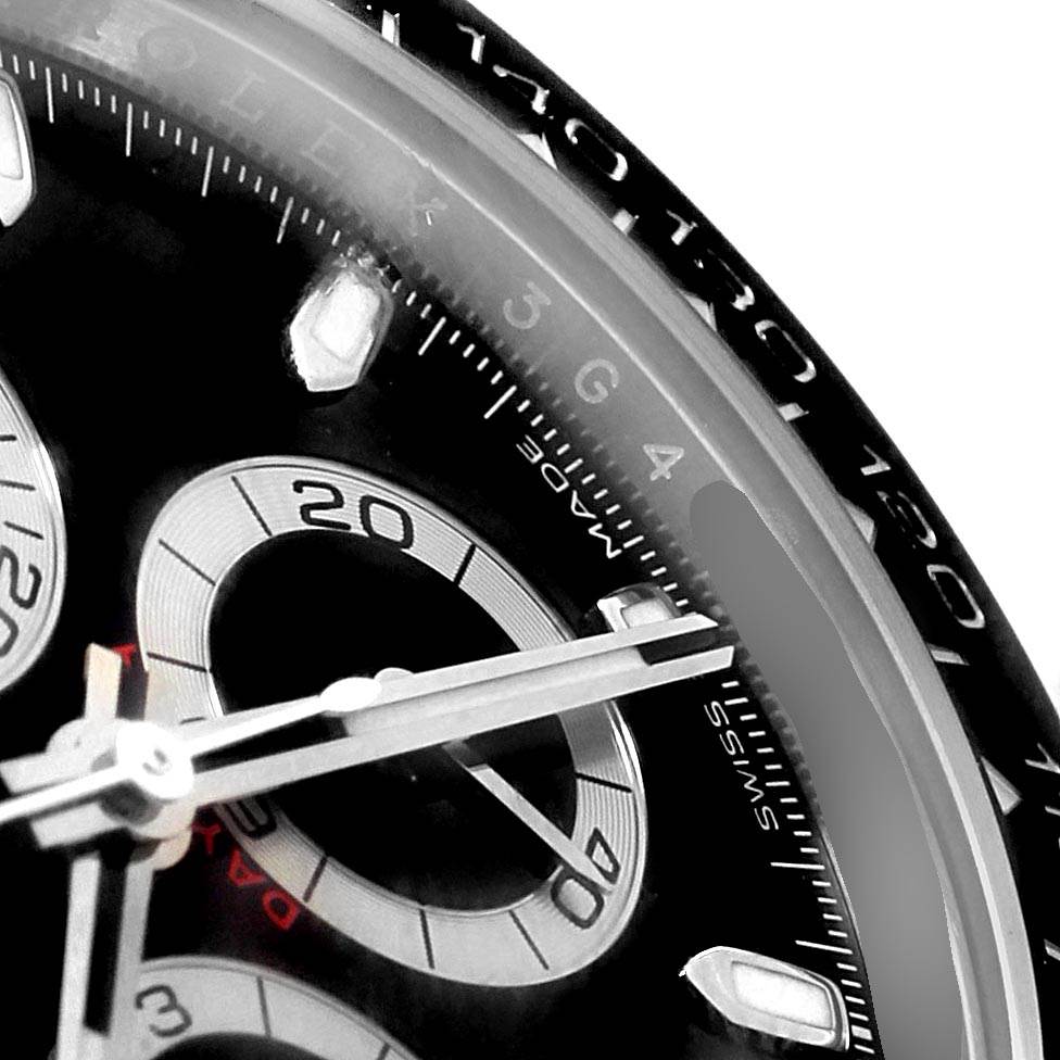 A close-up of the Rolex Daytona 116500 Men's Stainless Steel Black Dial 116500 Men's Stainless Steel Black Dial watch face shows the dial, hands, and part of the bezel.