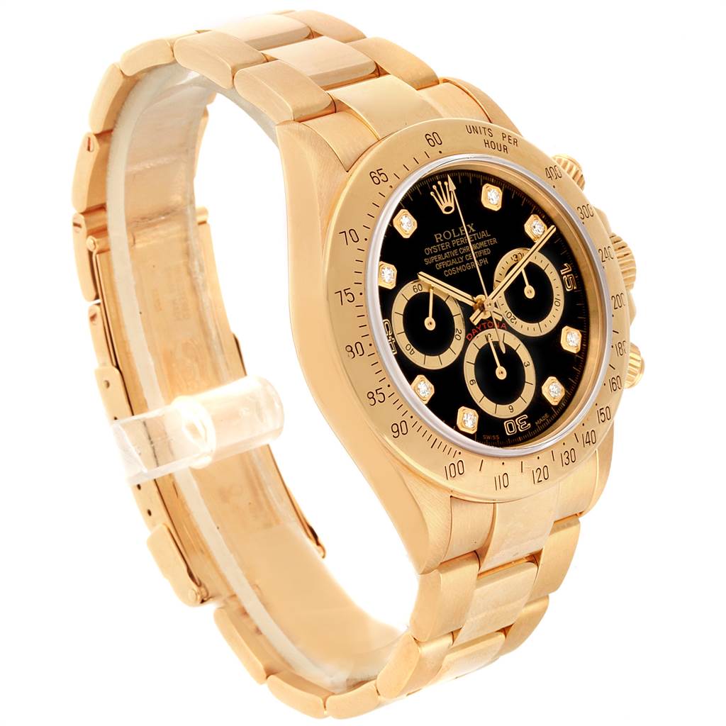 This Rolex Daytona 16528 Men's Yellow Gold Black Dial 16528 Men's Yellow Gold Black Dial watch is shown at an angled view, displaying the black dial, gold bracelet, and chronograph subdials.